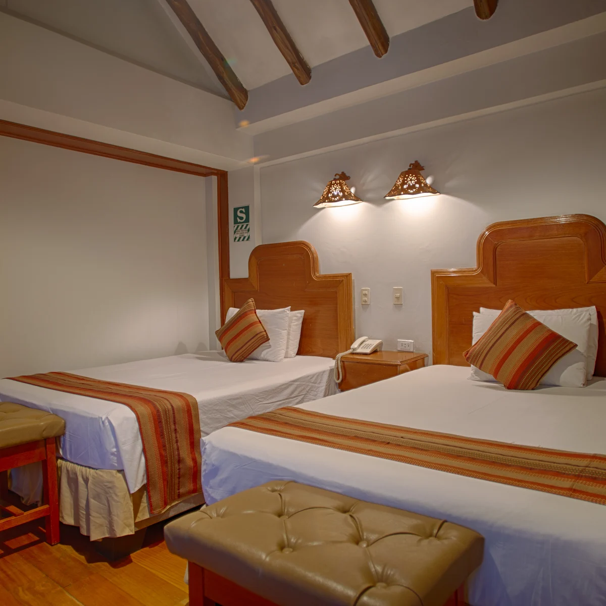 Double Room at Munay Wasi Inn in Cusco with two full beds, 167 square feet, private bathroom, flat-screen TV, minibar, and free Wi-Fi.