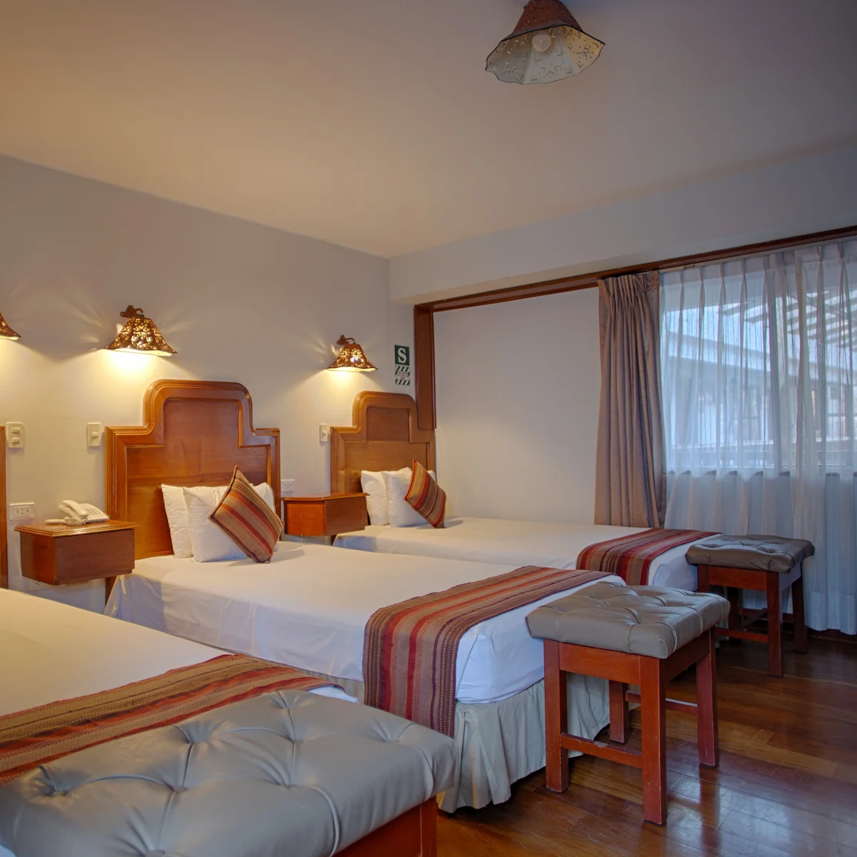 Triple Room at Munay Wasi Inn in Cusco with three twin beds, 172 square feet, private bathroom, flat-screen TV, minibar, and free Wi-Fi for three guests.